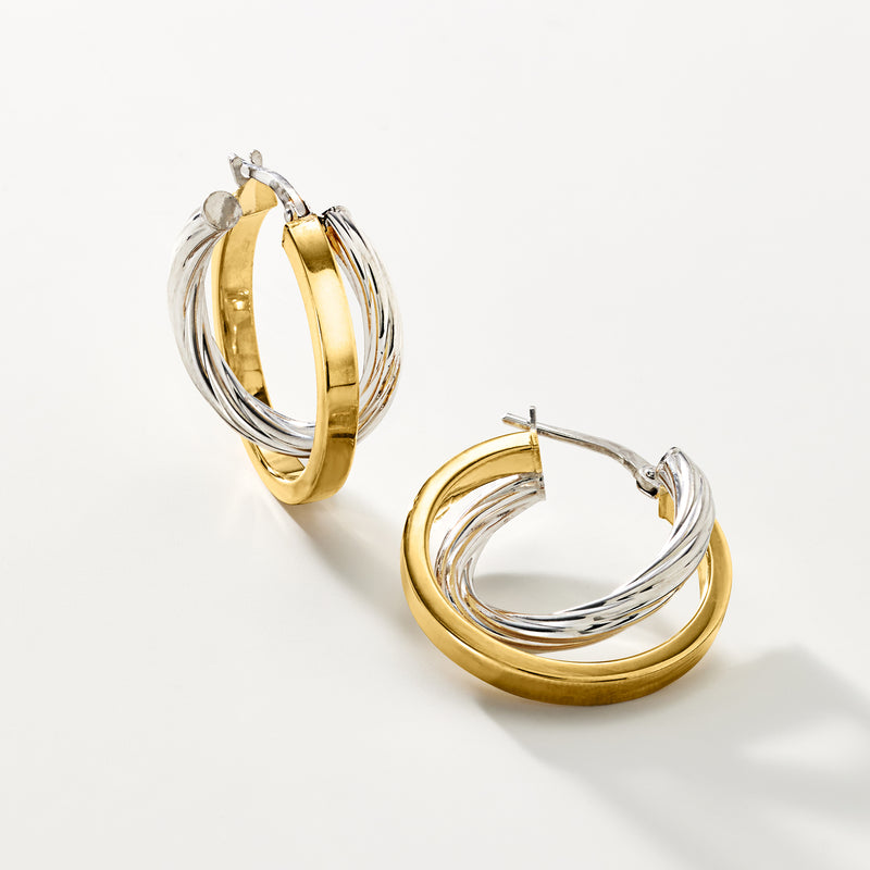Two-tone double hoop earrings with gold outer band and silver inner hoops