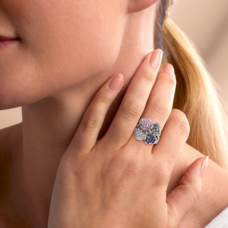 14kt white gold clover ring with pink and blue stones on a hand