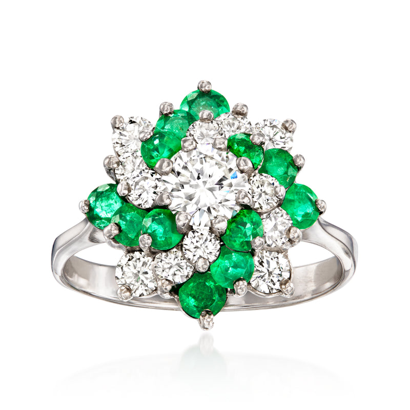 14kt white gold cluster ring with central round diamond and green emerald accents