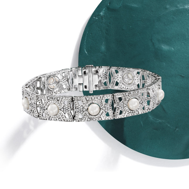 Sterling silver hinged bracelet with inset cultured pearls and diamond-like detailing