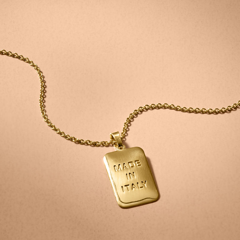 Gold tag pendant necklace detail: rectangular pendant with 