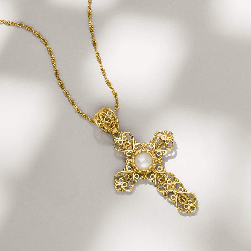 Gold cross pendant necklace featuring an oval mother-of-pearl cabochon