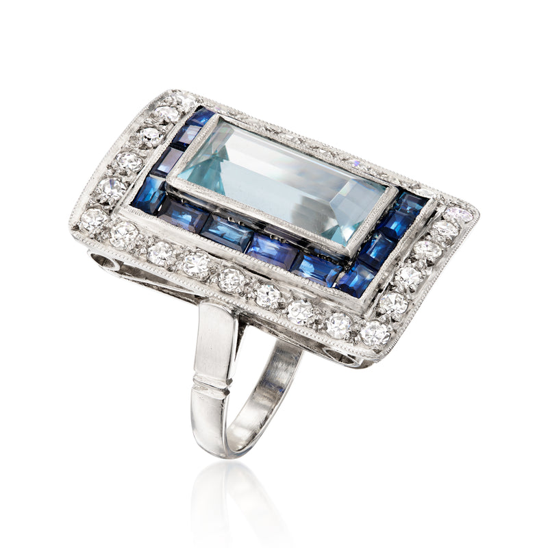 Platinum vintage ring side view with aquamarine center, blue sapphire accents, diamonds