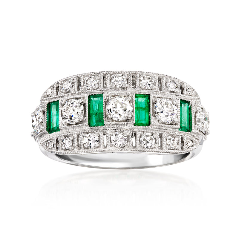 Vintage platinum ring with emerald-cut green emeralds and white diamond accents, full band.