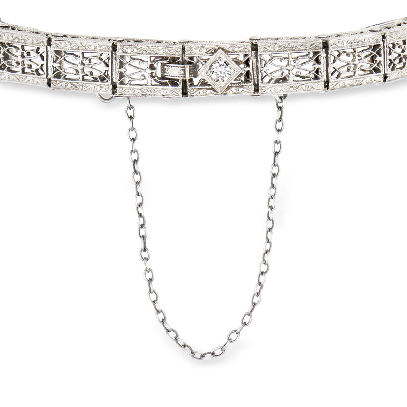 White gold filigree bracelet with repeating geometric settings and two side chain drops
