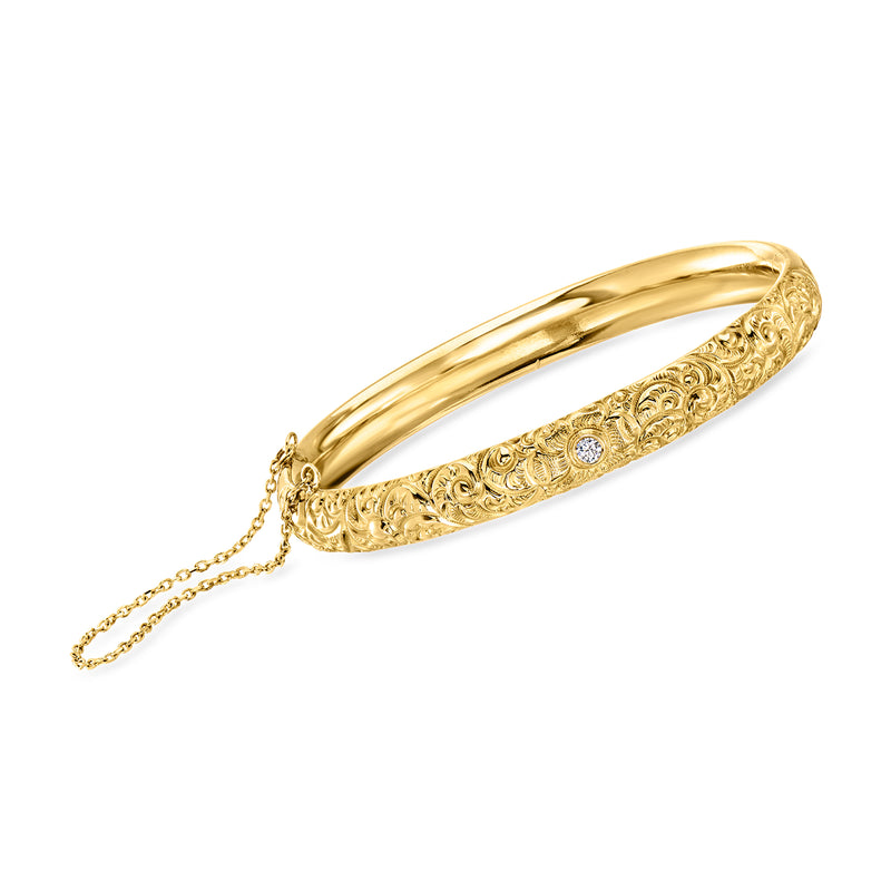 14kt yellow gold bangle bracelet with engraved swirl pattern and diamond accents, with chain