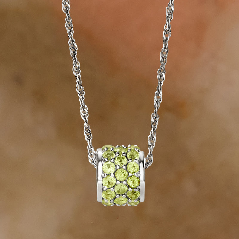 Sterling silver peridot barrel pendant with round light-green stones on chain