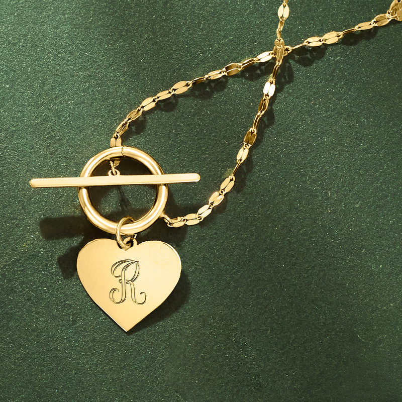 14kt yellow gold heart pendant with engraved letter K, worn on chain