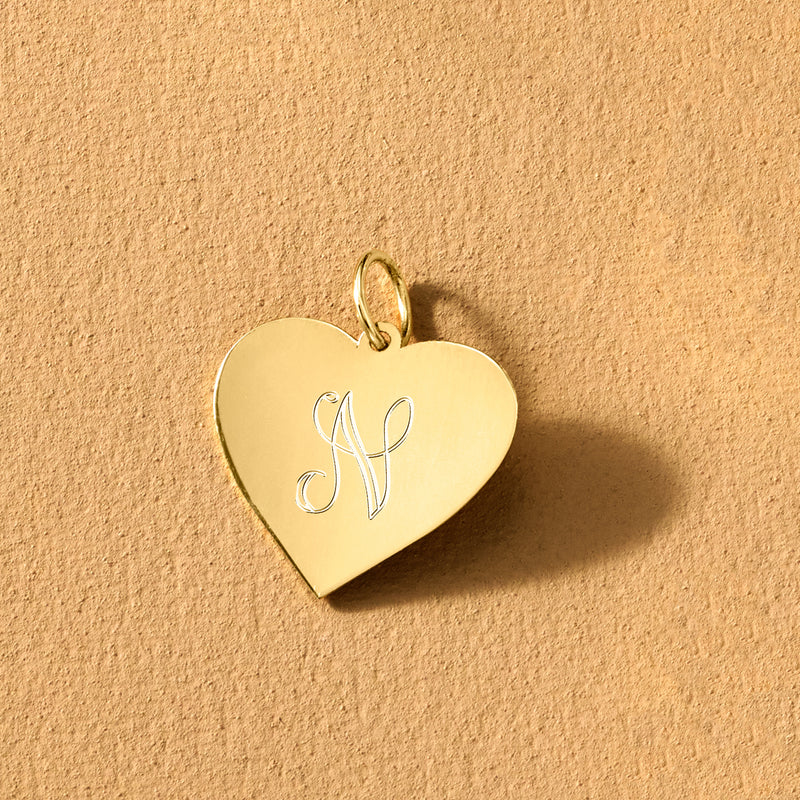14kt yellow gold heart pendant with engraved letter K, angled side view