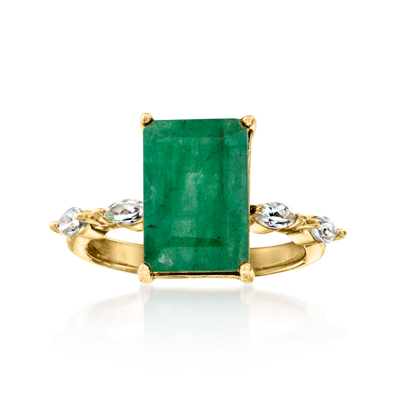 Gold ring with emerald-cut green gemstone and white topaz side accents