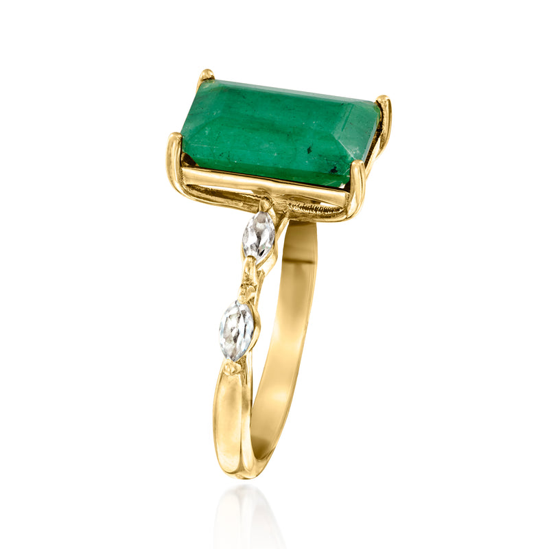 Gold ring with emerald-cut green center stone and dangling white topaz accents