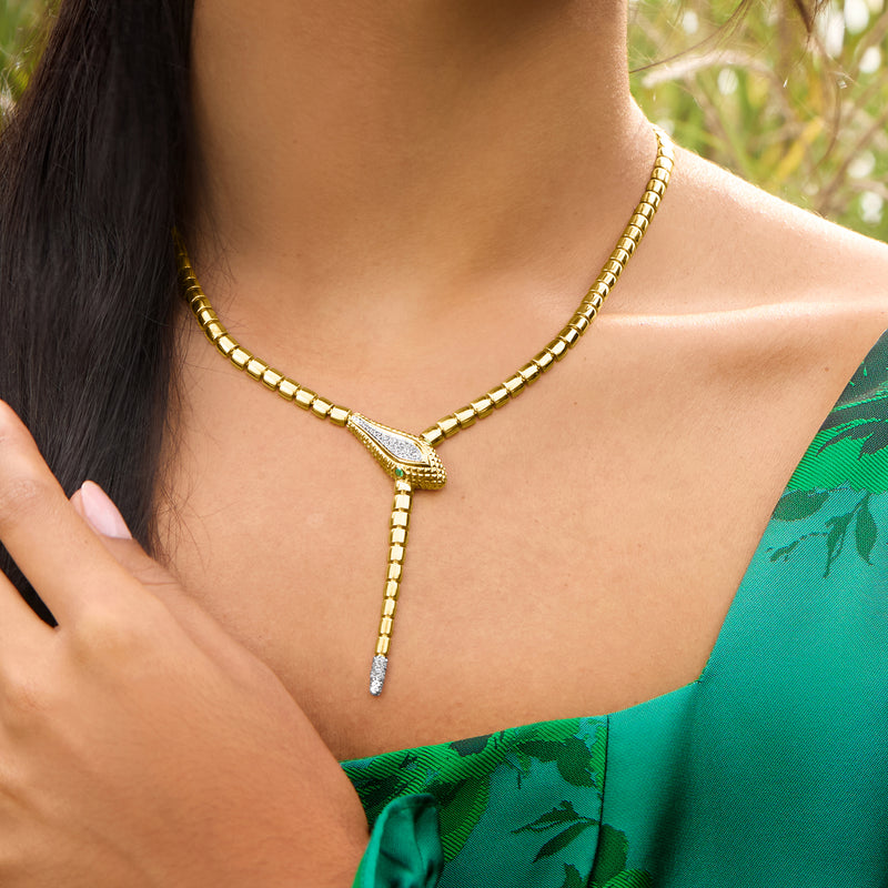 Gold-tone snake Y-necklace with textured links and pendant featuring small eye-like stones