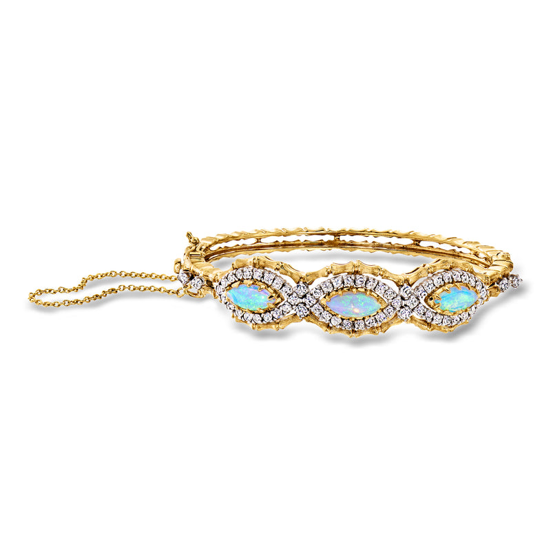14kt yellow gold bamboo-style bangle with three blue opal-like stones and diamond accents