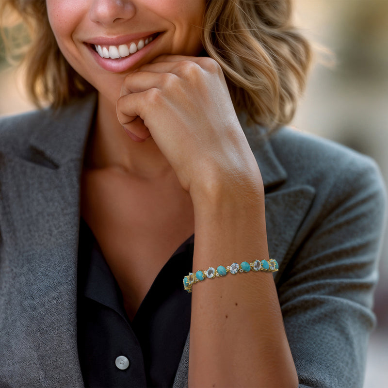 Turquoise and sky-blue topaz tennis bracelet on wrist in gold