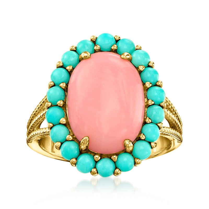 Oval pink coral gemstone ring with turquoise bead halo in gold-tone setting