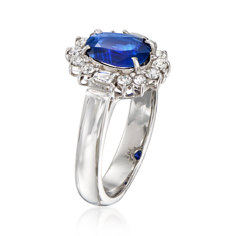 18kt white gold ring with blue oval sapphire and diamond halo, baguette accents