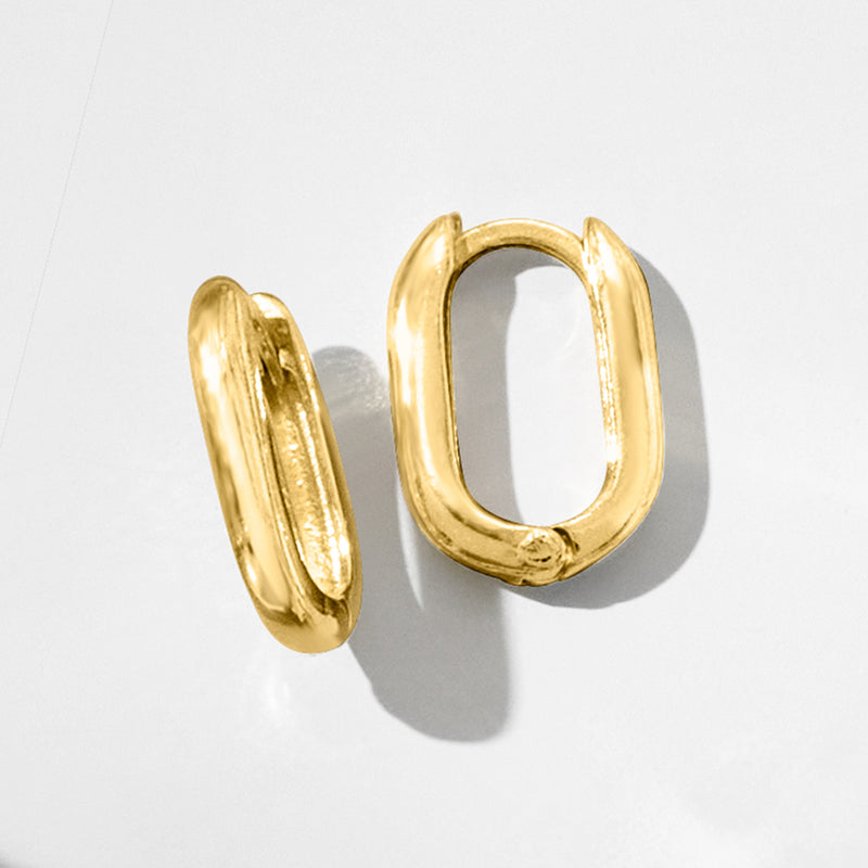 Gold oval huggie hoop earrings, side angle showing inner opening