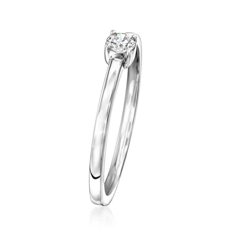 Slim white gold solitaire ring with round diamond prong setting, side view