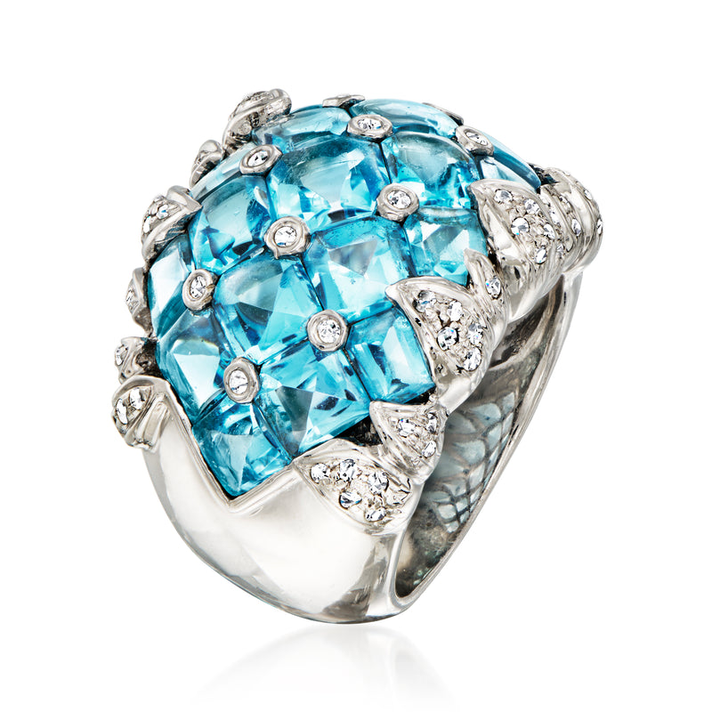 White gold ring with large blue topaz cushion, diamond accents and raised prong set band