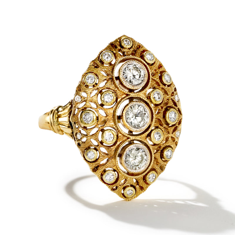 Vintage yellow gold diamond cluster ring with multiple round stones in raised halo setting