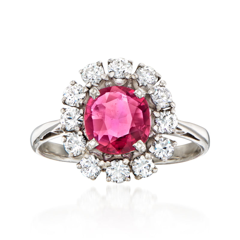 Platinum ring with oval pink ruby center and halo of round diamond accents
