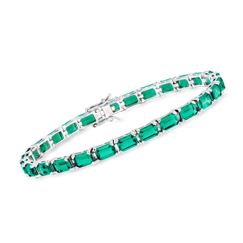 Sterling silver tennis bracelet with emerald-green emerald-cut stones and polished links.