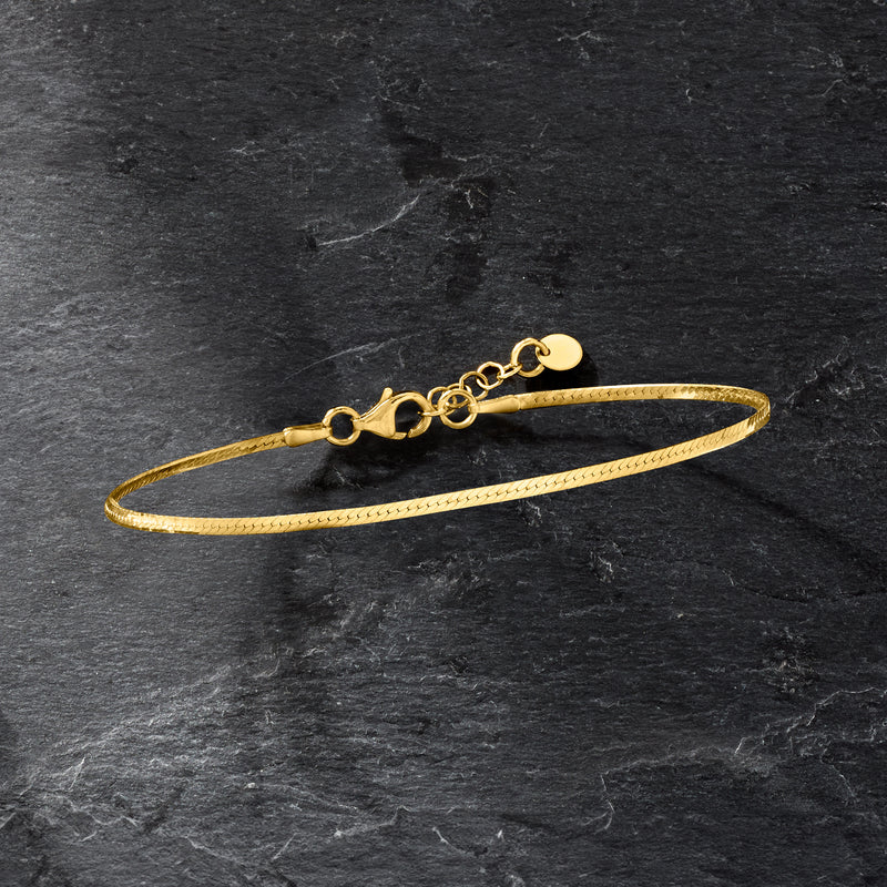 Gold over sterling herringbone bracelet viewed from side, with clasp and extender