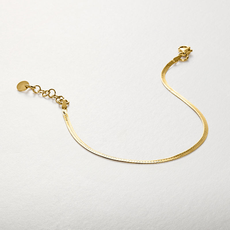 Gold over sterling herringbone bracelet with circular clasp and short chain extender