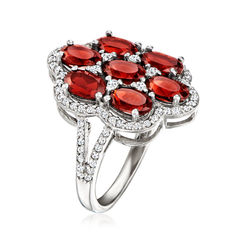 Sterling silver ring with red oval gemstone cluster and sparkling white zircon details
