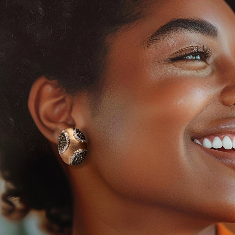 Clip-on diamond earrings on ear: black and white pave domed oval settings in gold