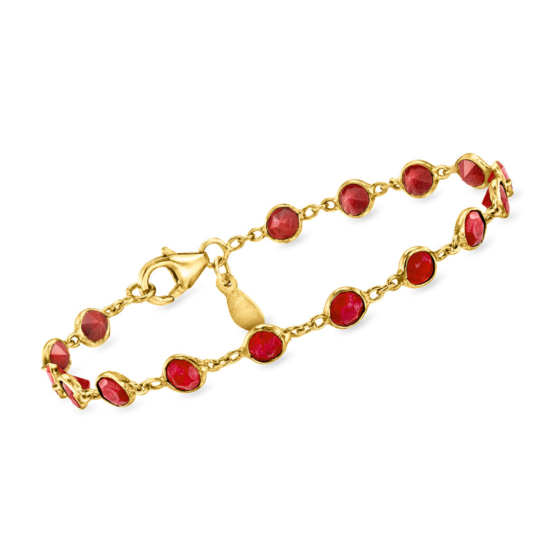 Gold tone bracelet with bezel-set oval red gemstones and small link chain