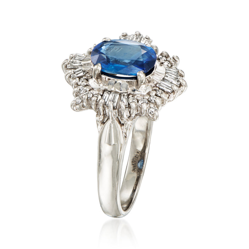 Platinum ring with oval blue sapphire and diamond cluster sides, curved band