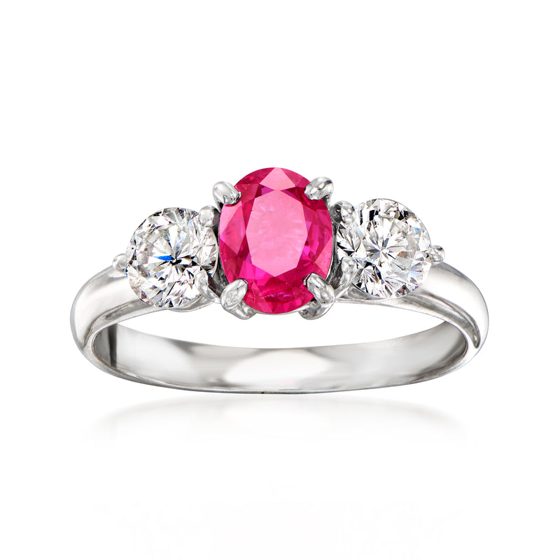 Platinum ruby and diamond ring with oval pink center stone and round side diamonds