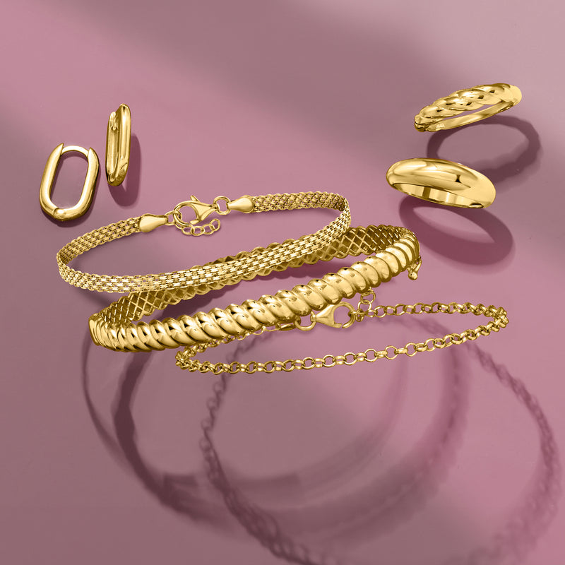 Gold domed ring with smooth curved face, shown with other jewelry
