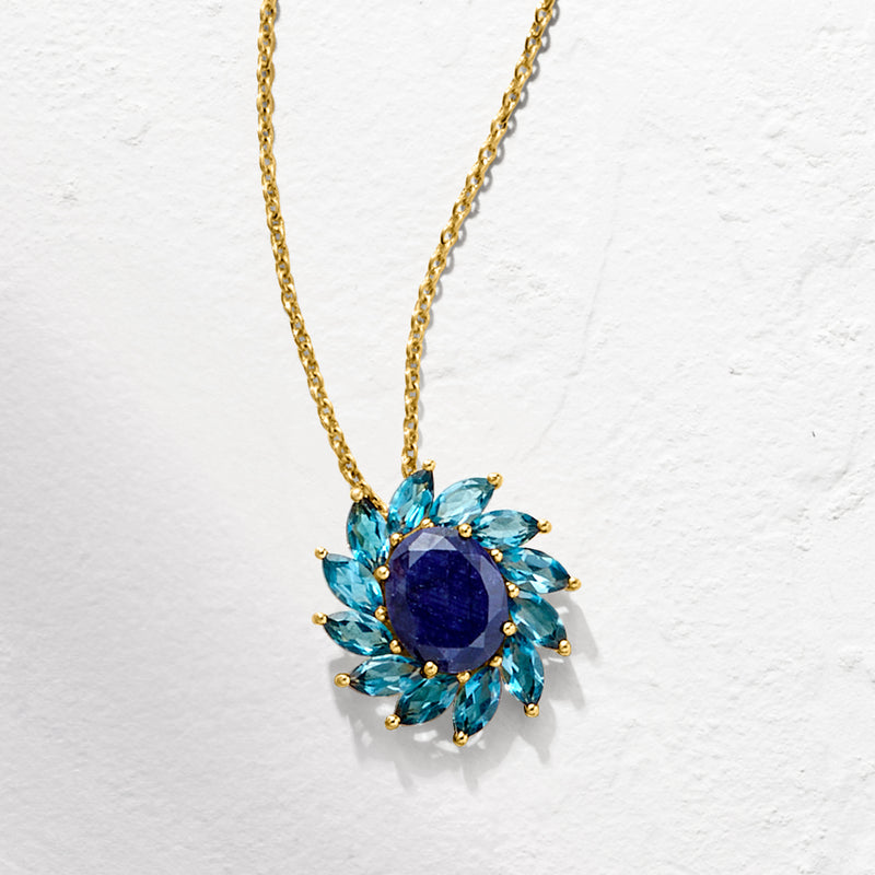 Blue flower pendant necklace with oval center sapphire and teardrop topaz accents