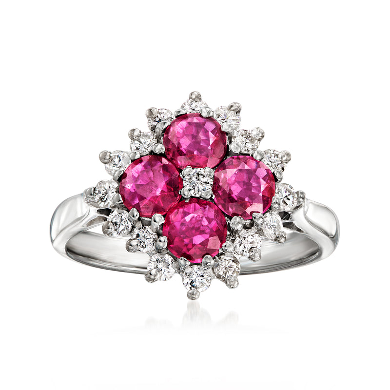 18kt white gold ring with three pink round gemstones and diamond halo accents