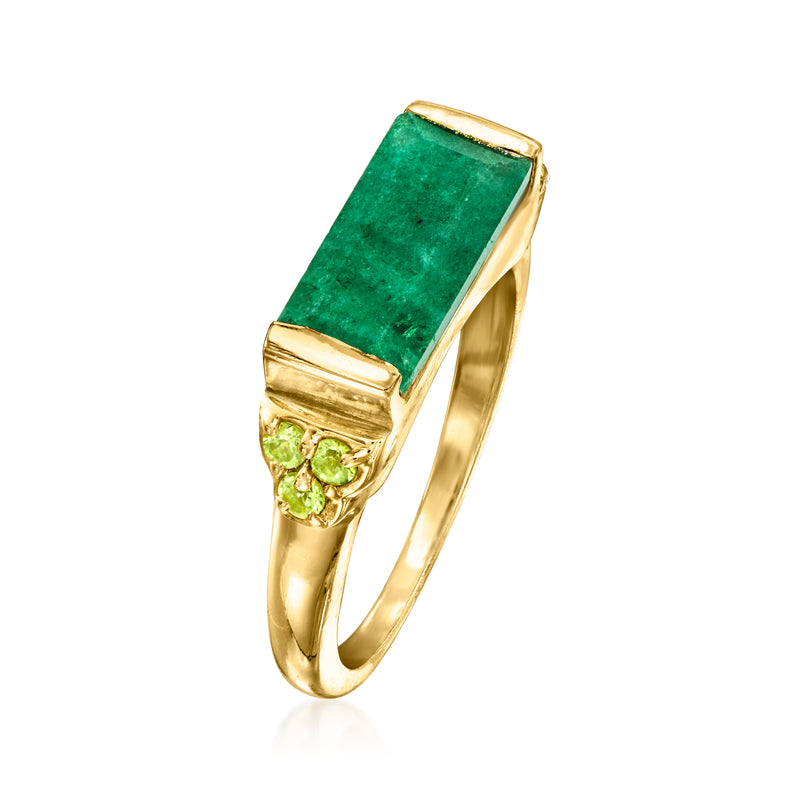 Gold ring angled view: rectangular emerald-green stone with peridot cluster accents