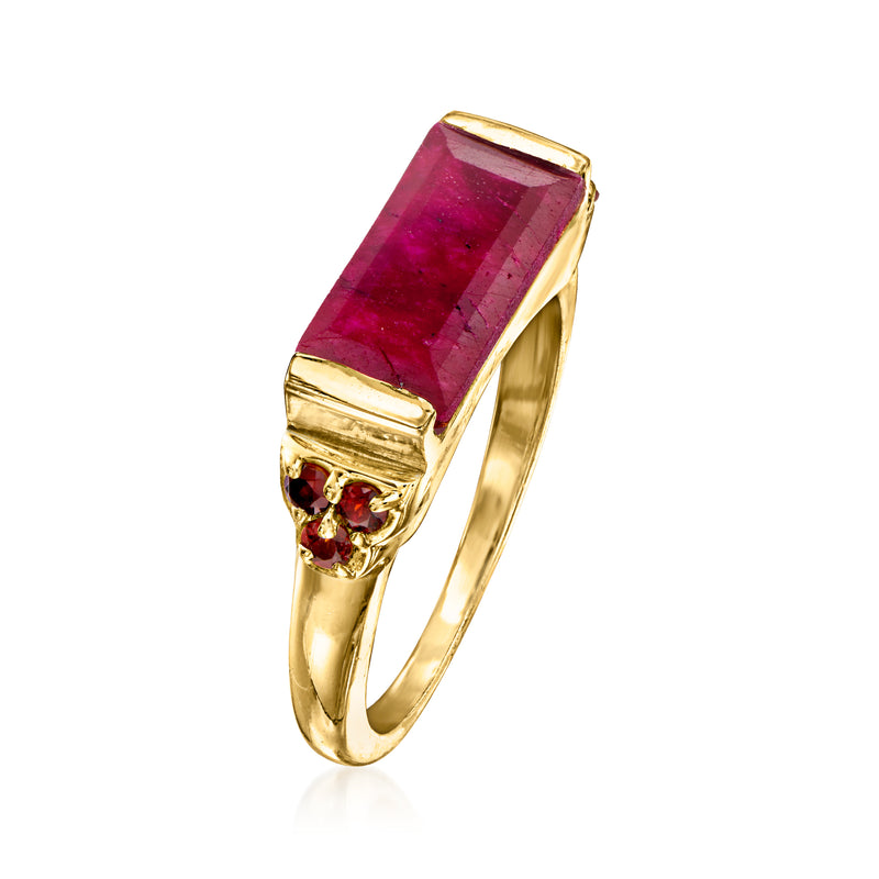 Gold ring with angled view of rectangular ruby center and round garnet side stones