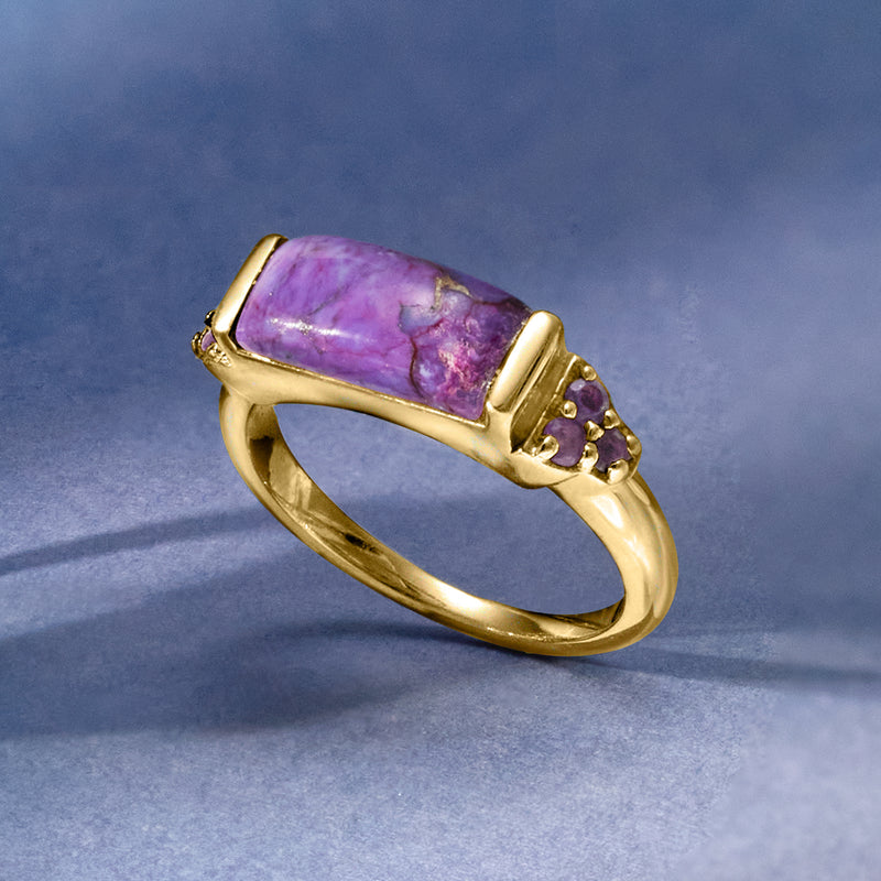 Gold ring with rectangular amethyst-style purple center and three small purple stones