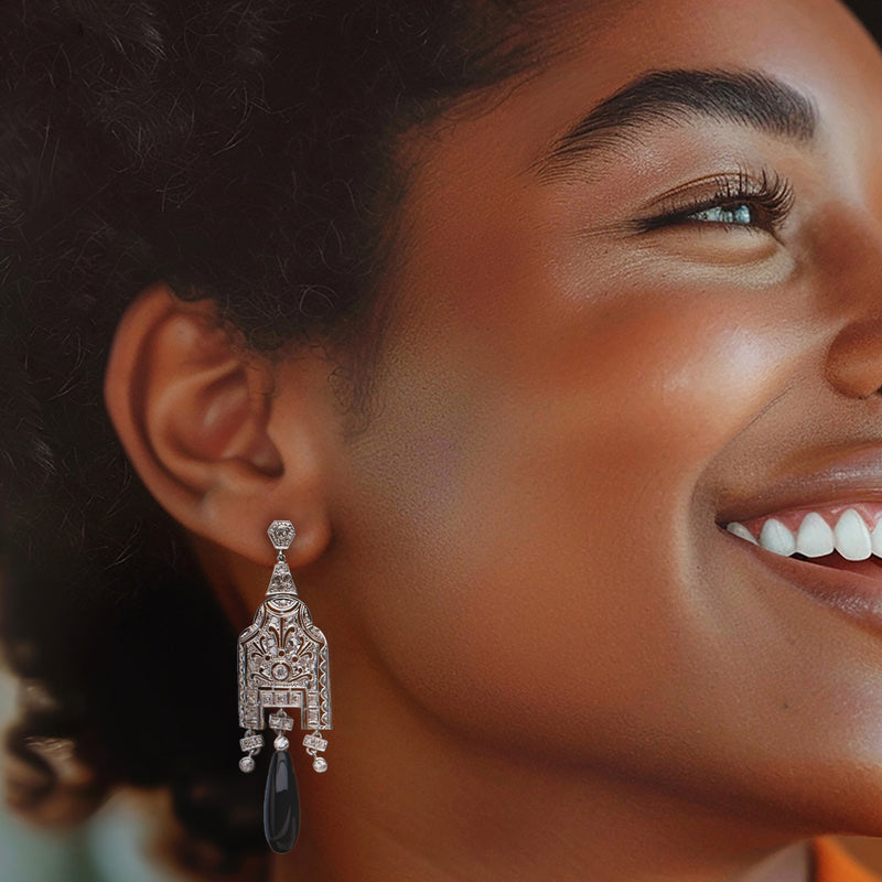 Diamond and onyx drop earring on model ear, ornate filigree, oval dark onyx dangle, stud post