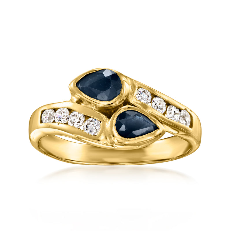 18kt yellow gold bypass ring with oval dark blue sapphire and diamond accents
