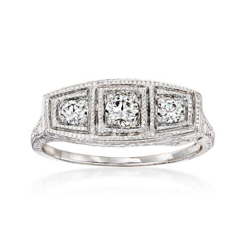 Vintage three-stone diamond ring in 14k white gold, rectangular settings, polished band.