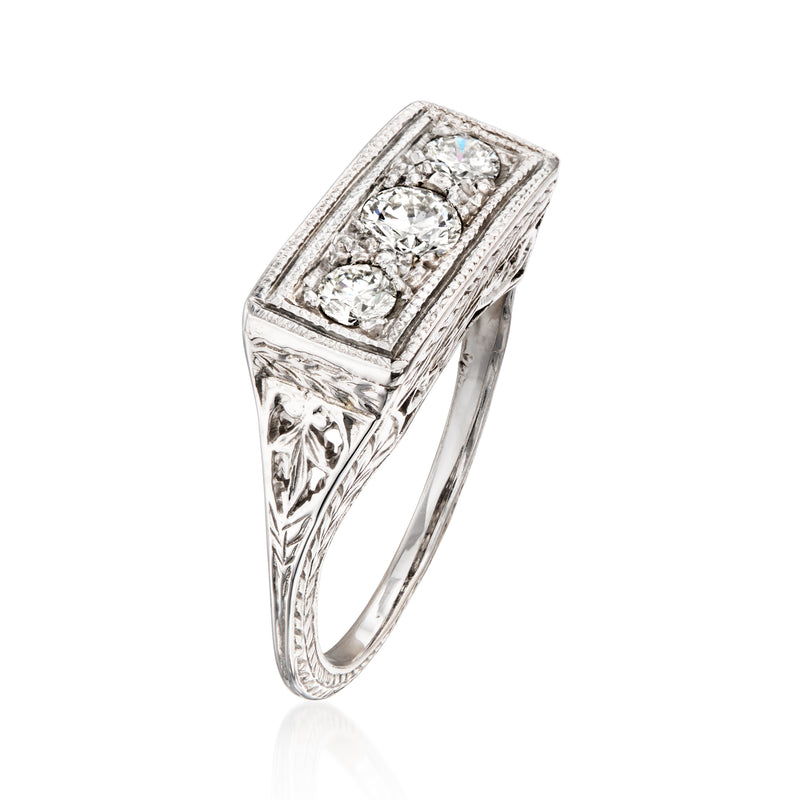 Side view of vintage three-stone diamond filigree ring with raised rectangular frame