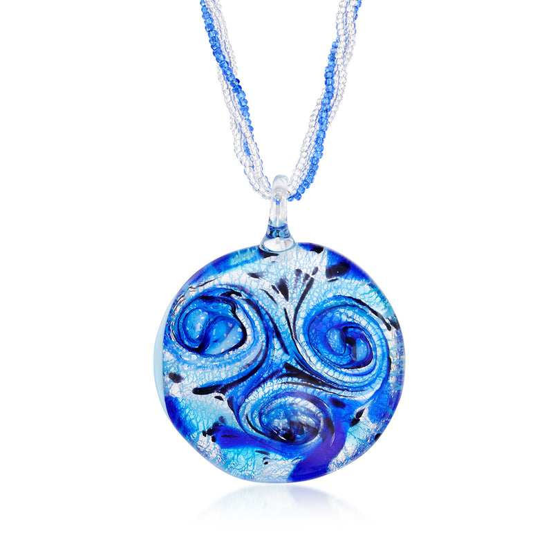 Round blue glass pendant necklace with swirling pattern and beaded blue cord