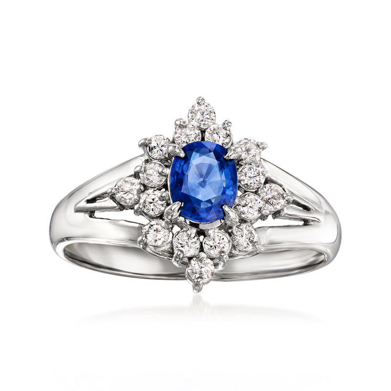 Platinum vintage ring with blue sapphire center and diamond halo and split shoulders