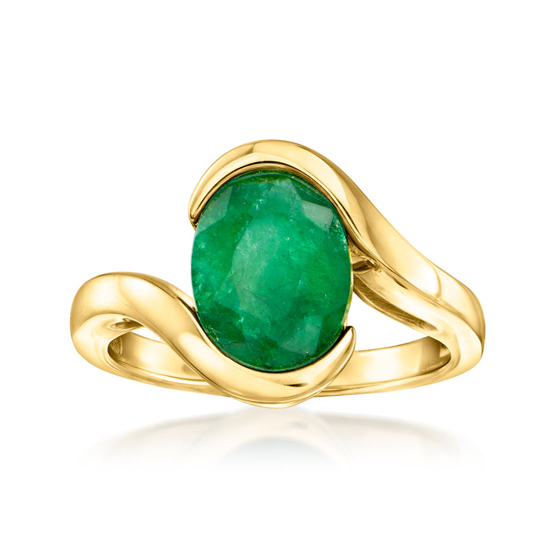 Gold swirl ring with oval green gemstone in bezel setting