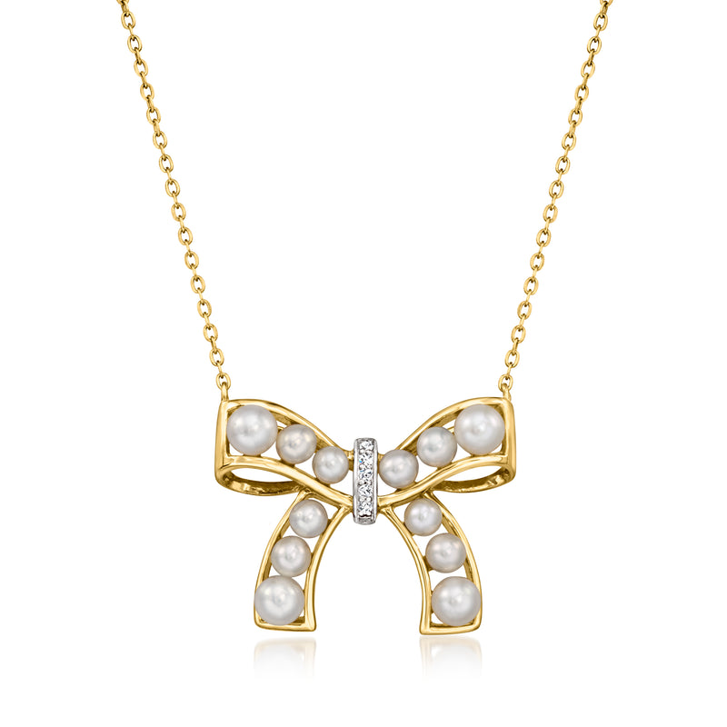 Gold-tone bow necklace with cultured pearl accents and a small diamond center