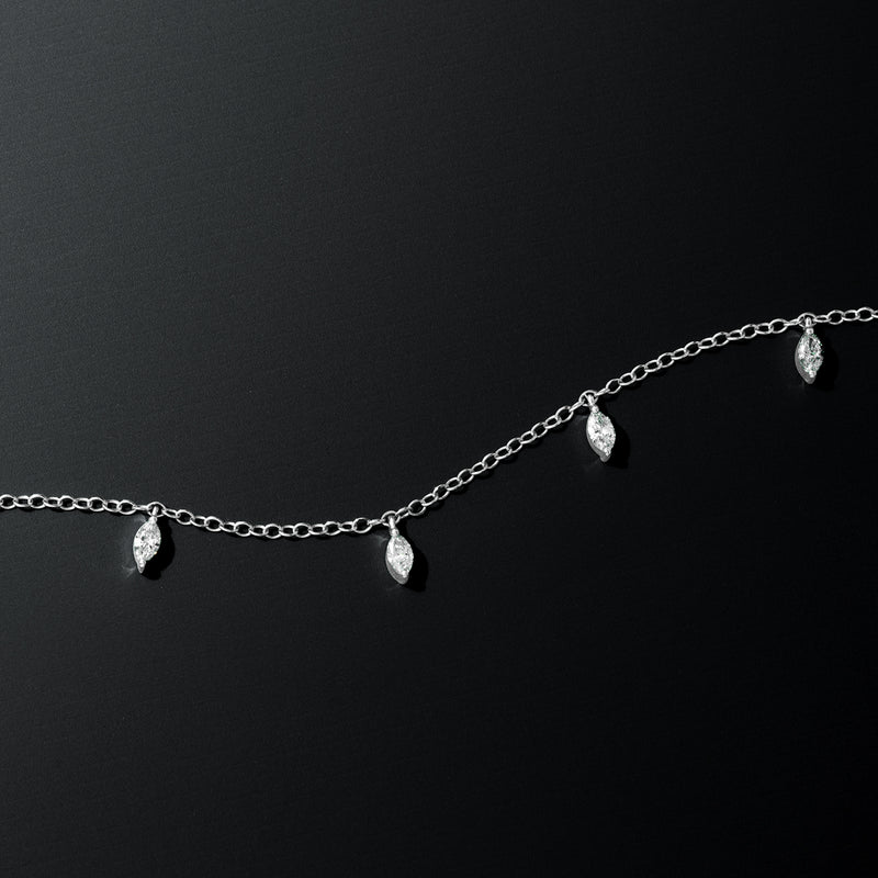 White gold chain bracelet with three marquise diamond drop stations, close-up
