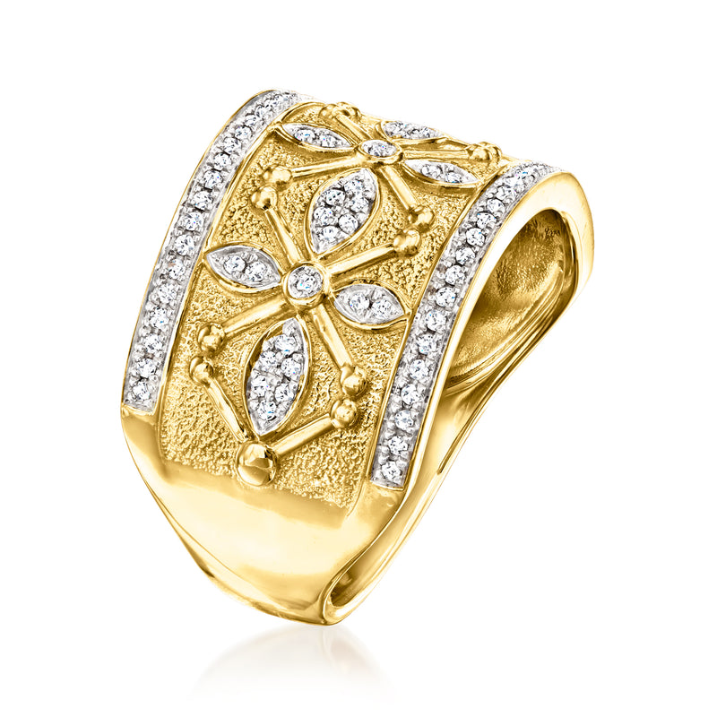 Gold diamond ring, angled view, with raised filigree pattern and round/oval stones