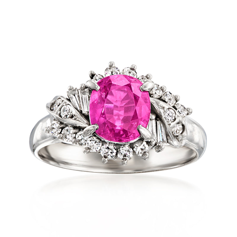 Platinum ring with cushion-cut pink sapphire center and diamond halo and side stones